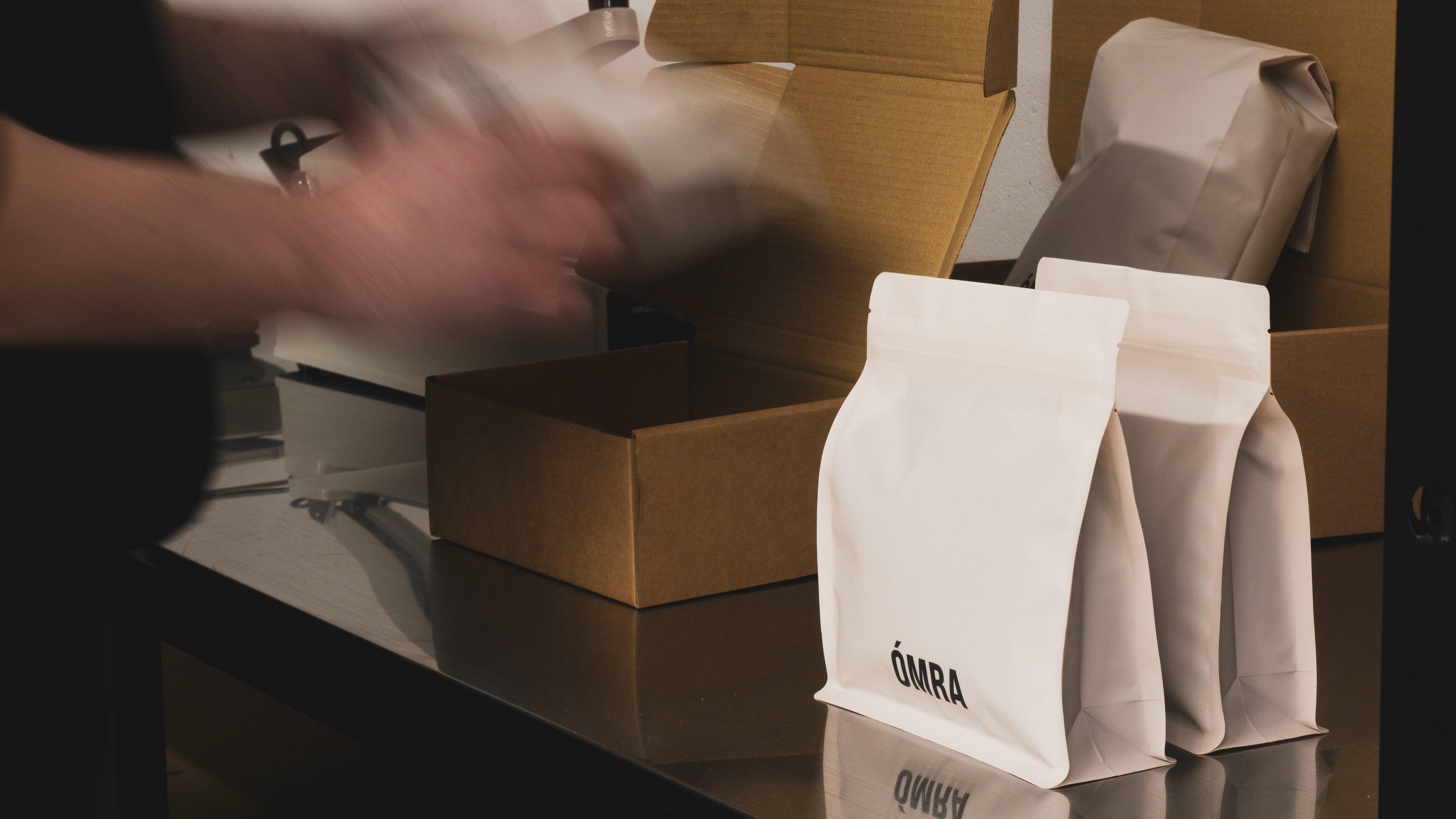 Bags of specialty coffee purchased online are being packaged for delivery in the Ómra Coffee Roastery